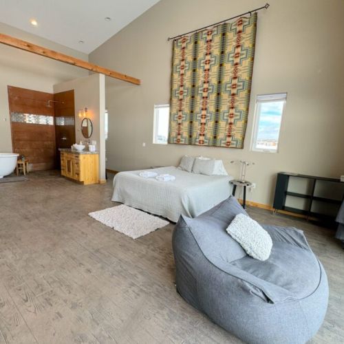 Enjoy loft-style living in beauty of Teton Valley! Bedroom #1 features tall ceilings, a king bed, an en suite bath, and a spectacular view of the Tetons.