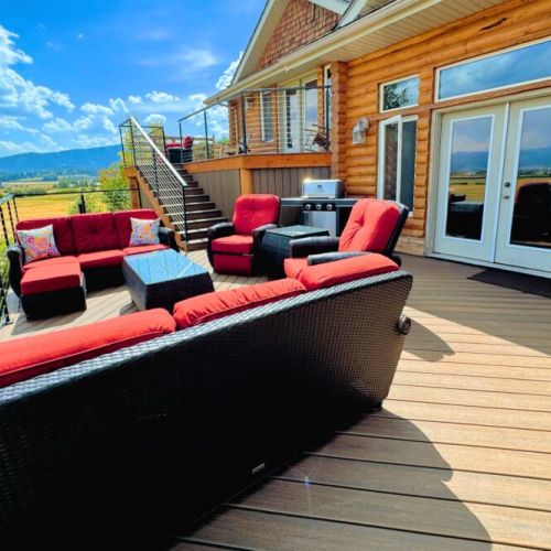The expansive back deck is the perfect place to hang out with family, cook on the grill, and enjoy the spectacular view.
