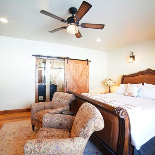 The master bedroom has a king bed and a huge en suite bath, as well as a large wardrobe, a TV, and a beautiful view of the Tetons.
