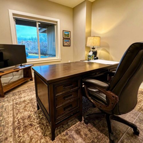 In case you have to work-from-home, there is an office off of the living room that is equipped with a desk, its own TV, and a view out in the front yard.