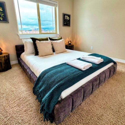 Bedroom #3, with its chic, boho styling, has a queen bed and a charming vibe.