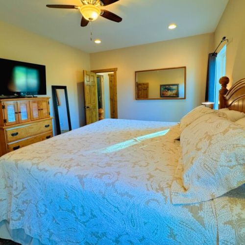 The primary bedroom features a king bed, a large en suite bathroom, and a walk-in closet.