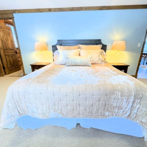 Bedroom #3, also located on the main level, has a queen bed, a dedicated workspace, and an en suite bathroom.