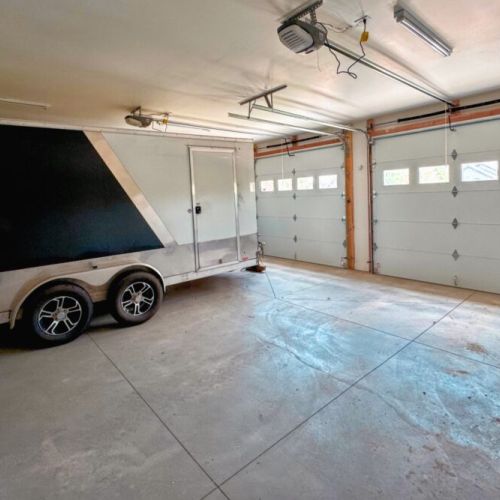 Keep your gear and your car dry using the available garage stall. (The owner stores a trailer year-round on the other side.)