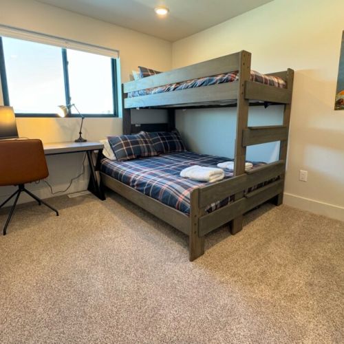Bedroom #3 has a twin XL-over-queen bunk bed, as well as its own workstation with a computer monitor.