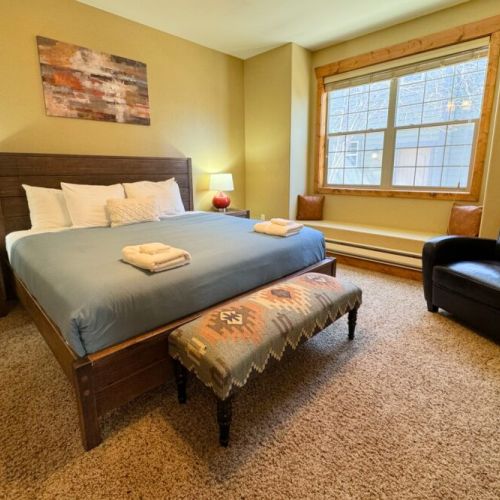 The master bedroom has a king bed, a terrific window seat, and an en suite bath.