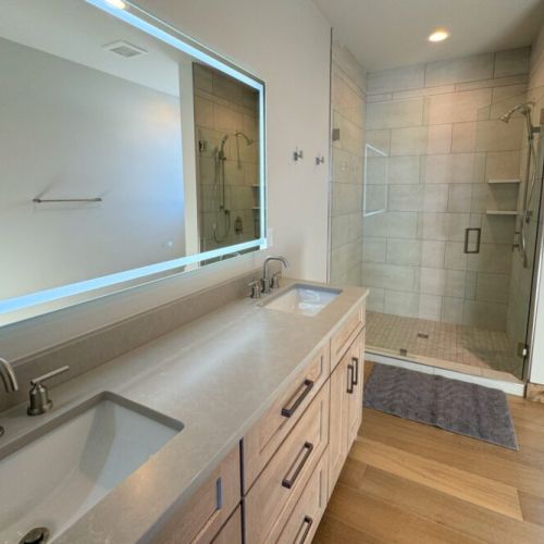 The primary en suite has an enormous double vanity, lighted mirror, walk-in shower, and even has a little view of the Tetons.