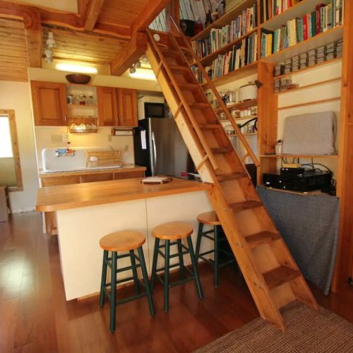 Access the second floor with a ladder, which is attached at both ends and has handrails for safety.