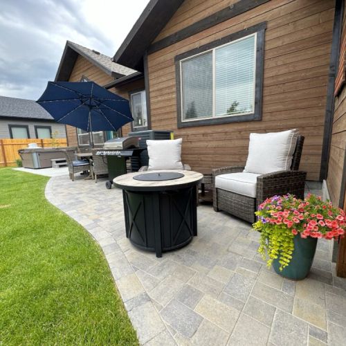 Make use of this robust outdoor space, which includes ample seating, a propane fire pit, a gas grill, and a hot tub.