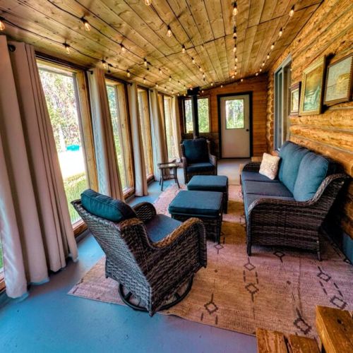 The enclosed porch allows you to enjoy the beauty of the surrounding trees from the comfort of the home.