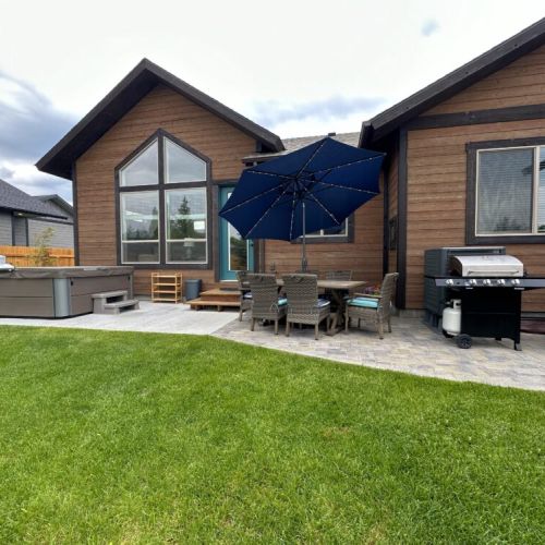 Make use of this robust outdoor space, which includes ample seating, a propane fire pit, a gas grill, and a hot tub.