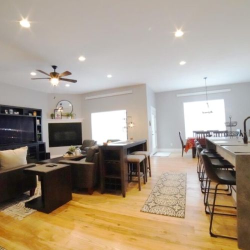 Whether you are relaxing in the living room, eating at the dining room table, or hanging in the kitchen, you are always a part of the fun in this home.