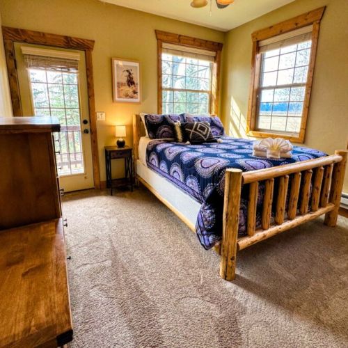 Bedroom #2 has a comfy queen bed with a large closet, a set of drawers, and great natural light.