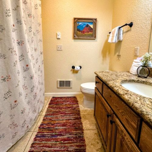 Bedrooms #2 and #3 share a full bathroom, which features a tub/shower combo and a large vanity with plenty of room for everyone's toiletries.