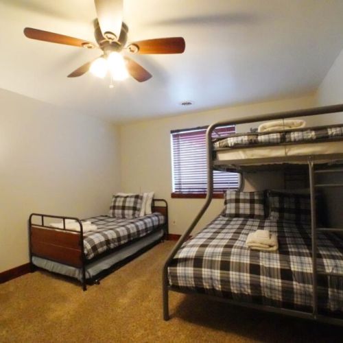 Bedroom #5 has a roomy bunkbed, as well as a twin. The room also enjoys a closet and dresser.