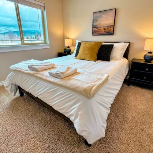 Bedroom #2 has a queen bed and a lovely view of the front yard.