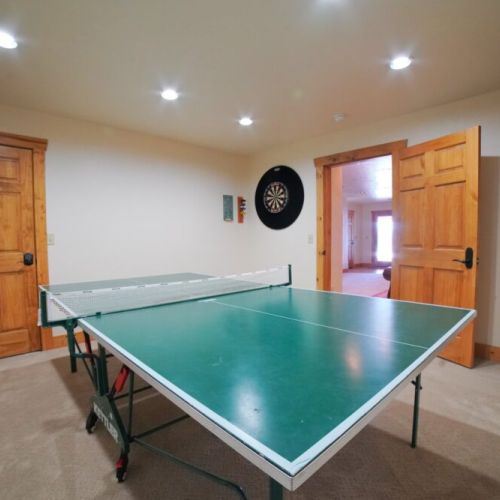 Just off the sitting room, you'll find a ping pong table and a dart board.
