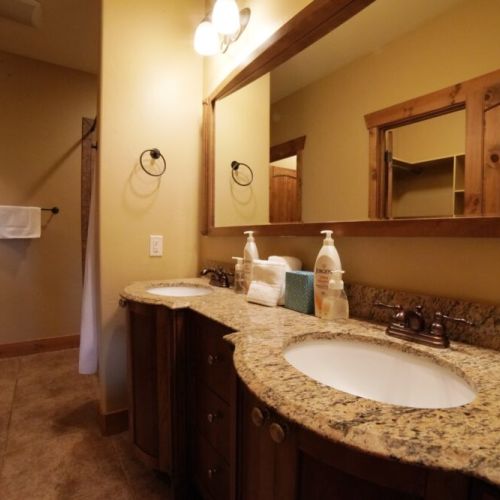 The en suite bath comes with a double vanity, large tub/shower combo, and a spacious closet.