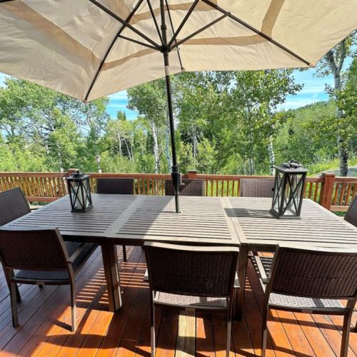 Gather around the outdoor table for a delicious meal.