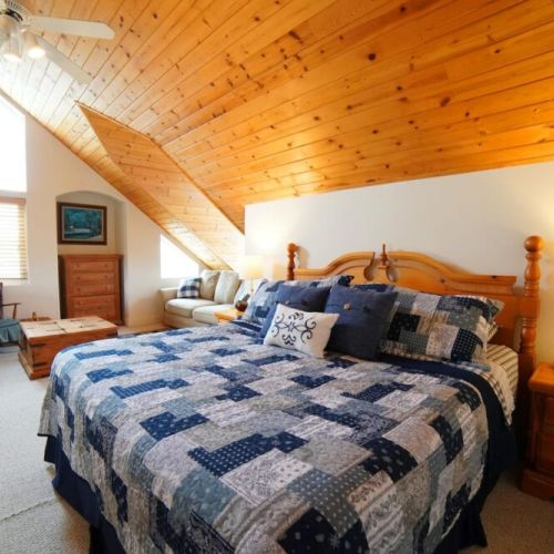The master bedroom, located on the 3rd floor, features a king bed, its own sitting area with a TV, and an en suite bathroom.