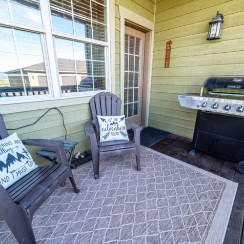 Just off the living room is a porch with comfortable seating and a propane grill.