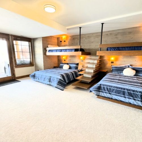 Bedroom #4, located on the lower level, features two custom twin-over-queen bunks. But these aren't your average bunk beds — the sturdy construction and space allows for people of all ages to use them comfortably.