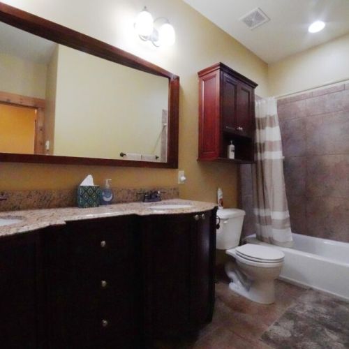 This bathroom, shared by bedrooms #2 and #3, has large tub/shower combo and a double vanity.
