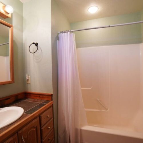The master en suite bathroom has a lovely vanity and a tub/shower combo.