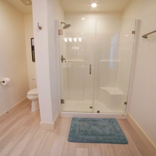 The en suite bath enjoys a spacious vanity and a walk-in shower.