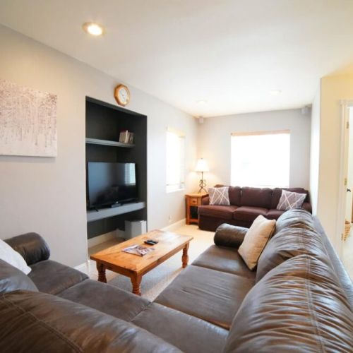 The 2nd floor features another living space, with a large sectional and a TV.