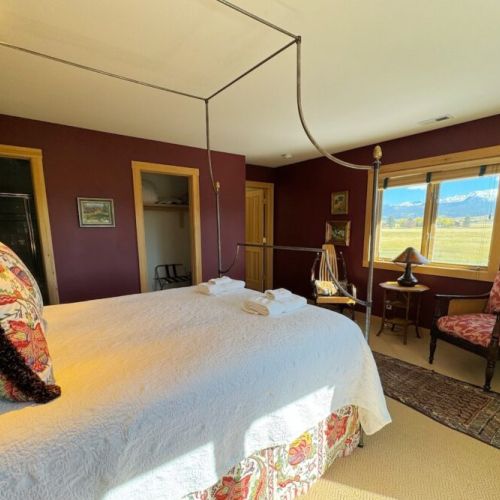 Bedroom #2 enjoys a queen bed, an en suite bath, and a lovely view of the Tetons.