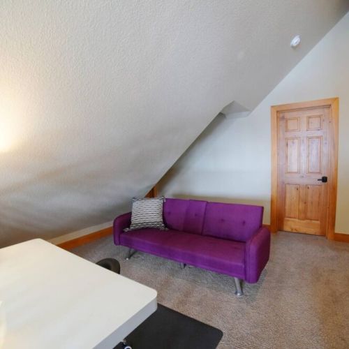 The upstairs common area has a sleeper sofa and a sit/stand desk, which is ideal for work- or school-from-home needs.