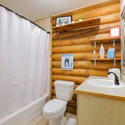The upstairs bathroom, shared by Bedroom #1 and the main living area, has a tub/shower combo and comes stock with shampoo, conditioner, and body wash.