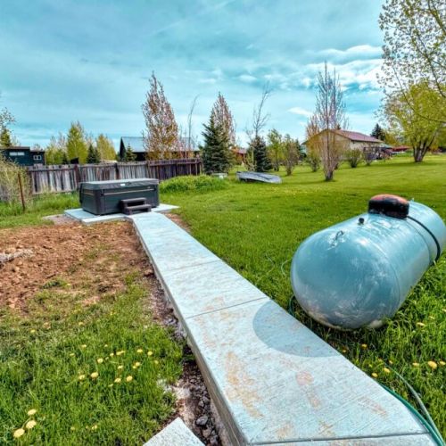 The hot tub is located in the backyard.