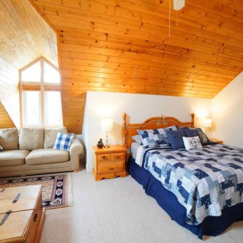 The master bedroom, located on the 3rd floor, features a king bed, its own sitting area with a TV, and an en suite bathroom.