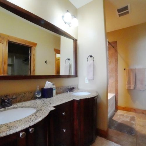The en suite bath has a double vanity and a large tub/shower.