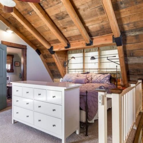 The master bedroom, located upstairs, has a king bed, en suite bathroom, a sauna, a dedicated workspace, and a private deck.