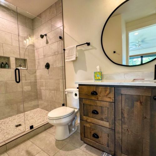 Bedroom #4's en suite features a large vanity and a step-in shower.
