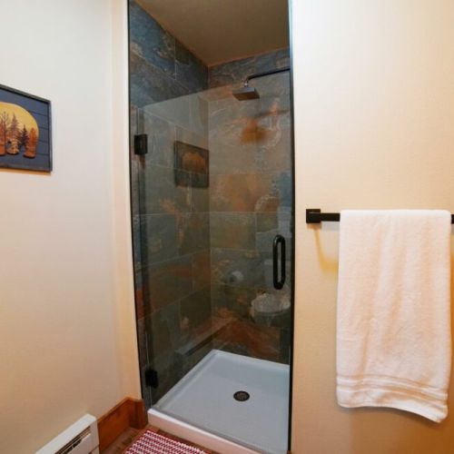 The downstairs hall has a full bath, complete with a walk-in shower.
