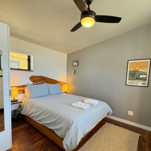The bedroom enjoys a queen bedroom, loads of storage space, a workspace, and laundry machines.
