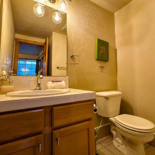 Down in the basement, bedroom #3 enjoys a twin-over-full bunk bed and an attached half-bath, as well as a TV — perfect for kids!