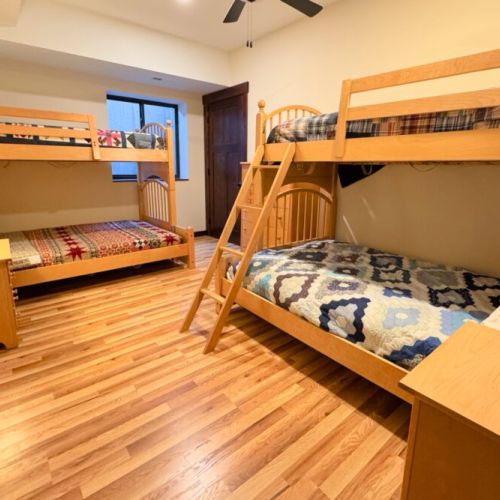 Bedroom #4, also located in the basement, has two twin-over-full bunk beds.