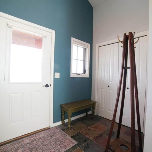 Kick your shoes off or stash your bags in the entryway — the closet also holds a terrific foldaway bed.