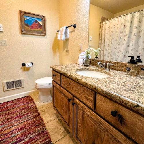 Bedrooms #2 and #3 share a full bathroom, which features a tub/shower combo and a large vanity with plenty of room for everyone's toiletries.