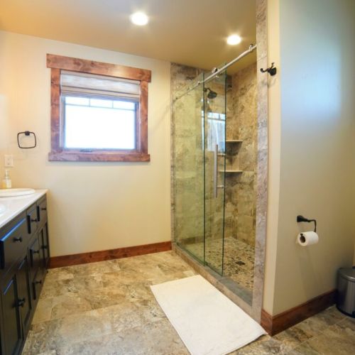 Bedroom #2's en suite bath has a double vanity and a large walk-in shower.