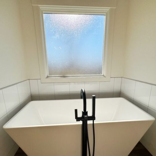 The primary en suite has an expansive double vanity, a walk-in shower, a luxurious tub, and a private water closet.