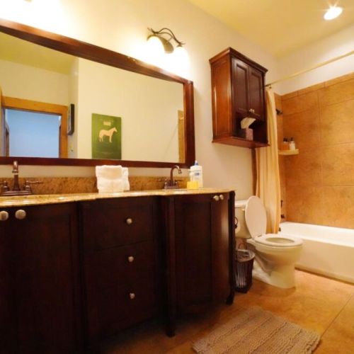 Bedrooms #2 and #3 share a bathroom, which has a double vanity and a large tub/shower combo.