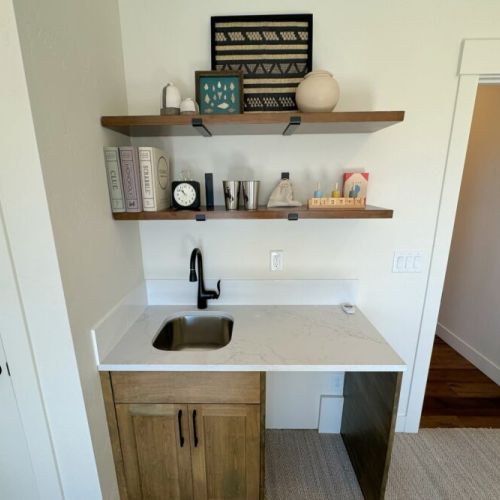 Also located upstairs is a beautiful sitting room, with tremendous natural light, an enormous TV, and a small wet bar.