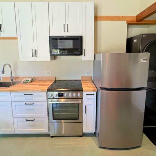 The master studio comes with a king bed, two twins, and an en suite bathroom, as well as a private kitchenette, sitting area, and a set of laundry machines.