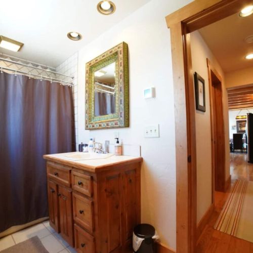 Just outside of bedroom #2's door is a full bath, complete with a vanity and shower/tub combo.